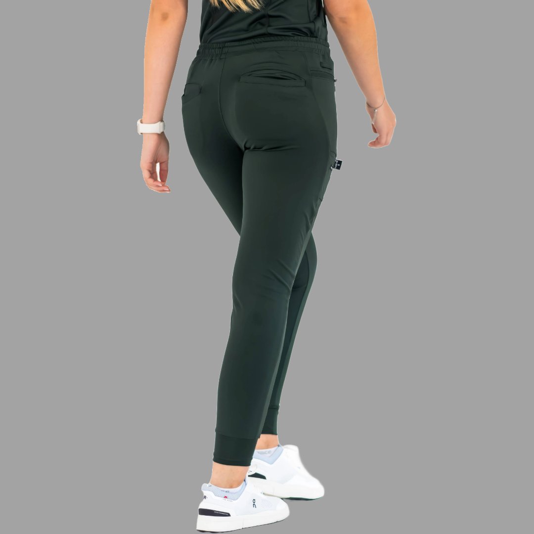 Back view of women's scrub joggers 920 super stretch bottle green with model standing straight.